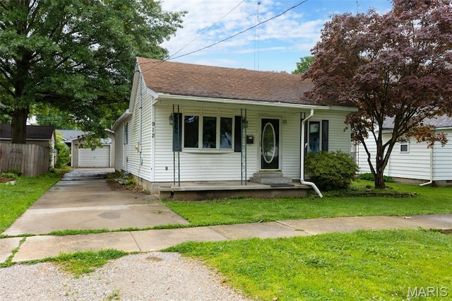 912 N Illinois Ave, Litchfield, IL 62056 - view of front of property featuring a front lawn, an outdoor structure, roof with shingles, and a porch