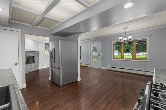 912 N Illinois Ave, Litchfield, IL 62056 - kitchen featuring appliances with stainless steel finishes, a baseboard radiator, a baseboard heating unit, dark wood finished floors, and arched walkways
