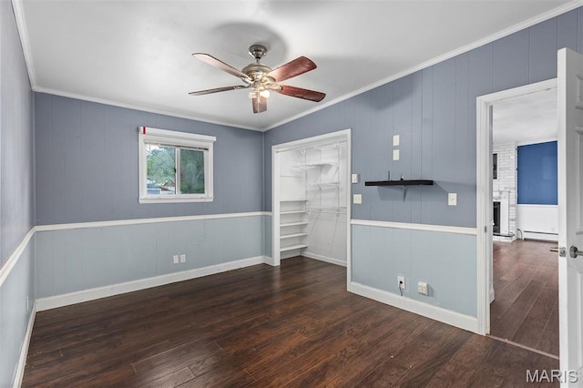 912 N Illinois Ave, Litchfield, IL 62056 - unfurnished bedroom featuring wood finished floors, a closet, a brick fireplace, ornamental molding, and ceiling fan