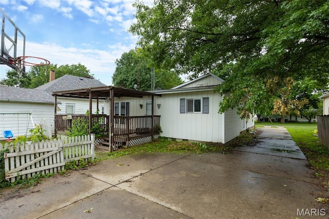 912 N Illinois Ave, Litchfield, IL 62056 - view of front of house with a deck, driveway, and board and batten siding