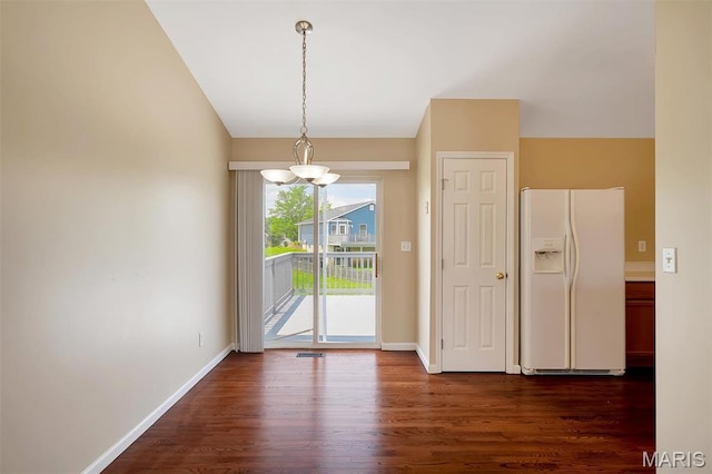 536 White Fence Dr, Wentzville, MO 63385 - unfurnished dining area with a chandelier, lofted ceiling, and dark wood finished floors