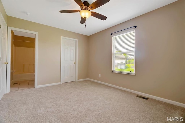 536 White Fence Dr, Wentzville, MO 63385 - unfurnished bedroom featuring light colored carpet, connected bathroom, and ceiling fan