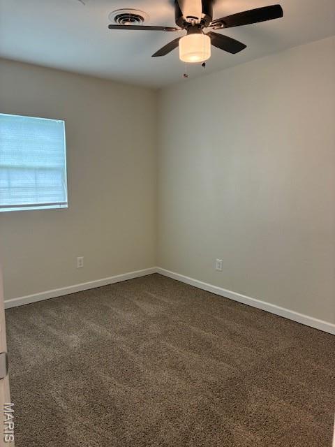 515 N 37th St, Belleville, IL 62226 - empty room with dark colored carpet and a ceiling fan