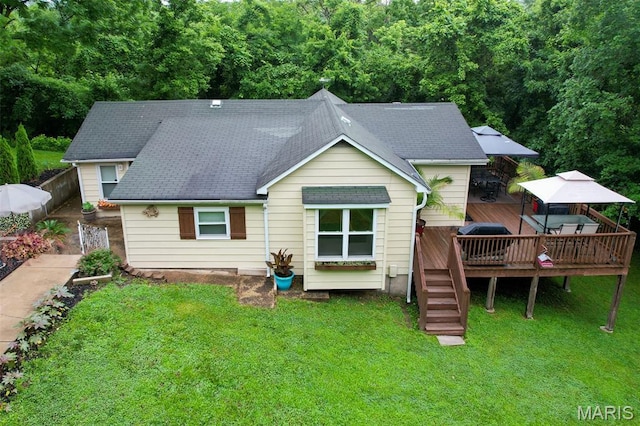 623 Boyne St, De Soto, MO 63020 - back of house with a wooden deck, a yard, a wooded view, and a shingled roof