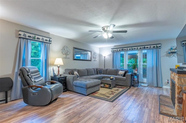 623 Boyne St, De Soto, MO 63020 - living room featuring wood finished floors, a ceiling fan, and a textured ceiling