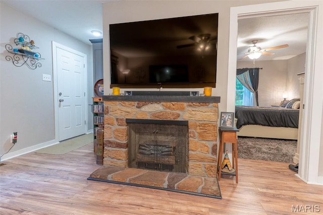 623 Boyne St, De Soto, MO 63020 - living area with wood finished floors, ceiling fan, and a fireplace