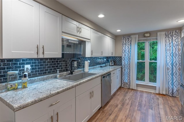 623 Boyne St, De Soto, MO 63020 - kitchen featuring stainless steel dishwasher, light wood-type flooring, white cabinets, backsplash, and recessed lighting
