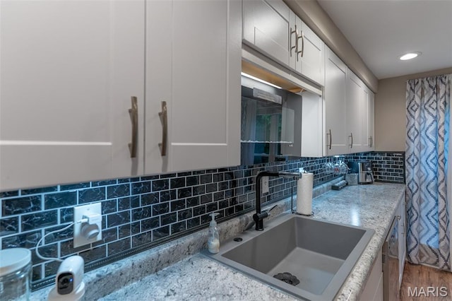 623 Boyne St, De Soto, MO 63020 - kitchen with decorative backsplash, white cabinets, light stone counters, and recessed lighting