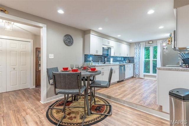 623 Boyne St, De Soto, MO 63020 - kitchen with light wood-type flooring, dishwasher, backsplash, light countertops, and recessed lighting