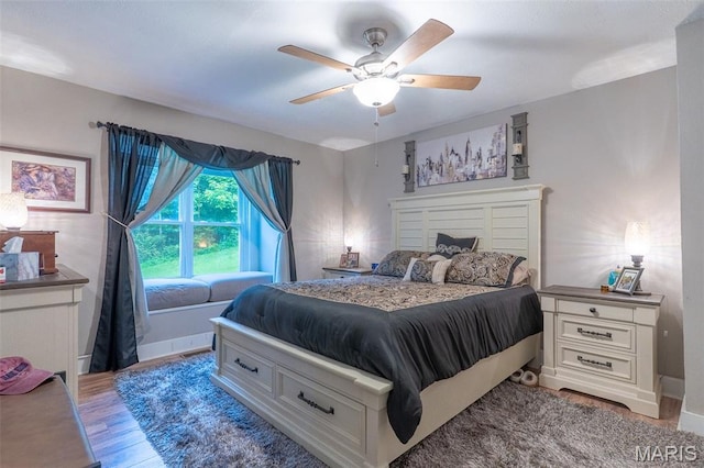 623 Boyne St, De Soto, MO 63020 - bedroom with light wood-style floors, ceiling fan, and a fireplace