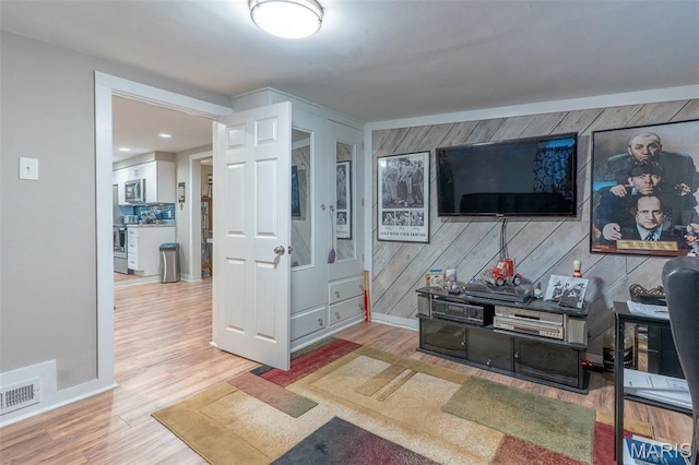 623 Boyne St, De Soto, MO 63020 - living room featuring wood finished floors and wood walls