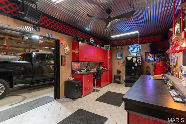 623 Boyne St, De Soto, MO 63020 - garage with freestanding refrigerator, ceiling fan, and a desk