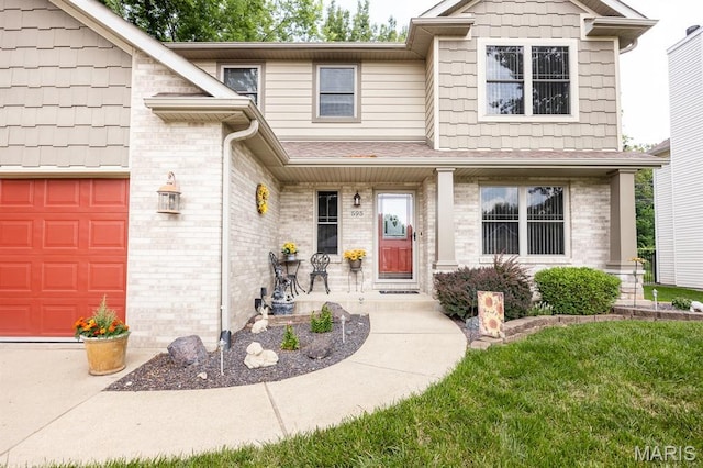 595 Chancellor Dr, Edwardsville, IL 62025 - view of front of property with brick siding and a garage