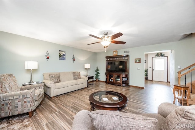 595 Chancellor Dr, Edwardsville, IL 62025 - living room featuring wood tiled floors, a ceiling fan, and stairway