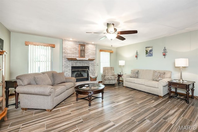 595 Chancellor Dr, Edwardsville, IL 62025 - living room featuring plenty of natural light, wood finished floors, a ceiling fan, and a brick fireplace