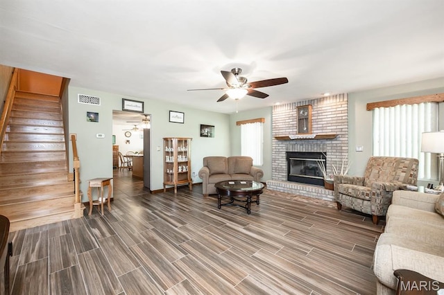 595 Chancellor Dr, Edwardsville, IL 62025 - living room with a ceiling fan, stairs, a fireplace, and wood finished floors