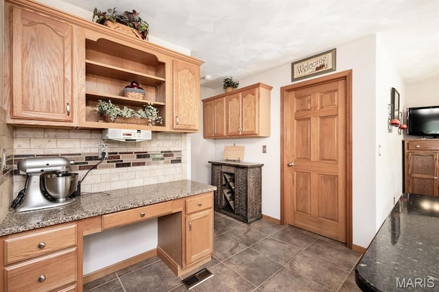 595 Chancellor Dr, Edwardsville, IL 62025 - kitchen with backsplash, dark stone counters, built in study area, open shelves, and light brown cabinetry