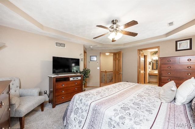 595 Chancellor Dr, Edwardsville, IL 62025 - bedroom featuring a raised ceiling, light colored carpet, ceiling fan, and ensuite bath