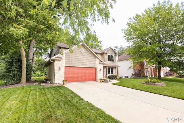 595 Chancellor Dr, Edwardsville, IL 62025 - traditional home featuring a front lawn, concrete driveway, a garage, and brick siding
