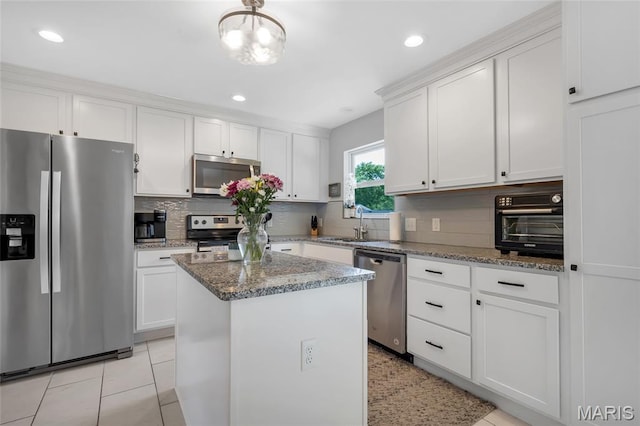4004 W Dr, Saint Peters, MO 63376 - kitchen featuring stainless steel appliances, backsplash, white cabinetry, a center island, and recessed lighting
