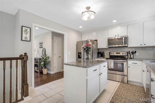 4004 W Dr, Saint Peters, MO 63376 - kitchen featuring stainless steel appliances, a kitchen island, stone counters, backsplash, and recessed lighting