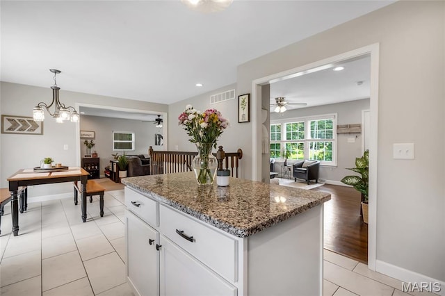 4004 W Dr, Saint Peters, MO 63376 - kitchen featuring a ceiling fan, open floor plan, a center island, stone counters, and recessed lighting