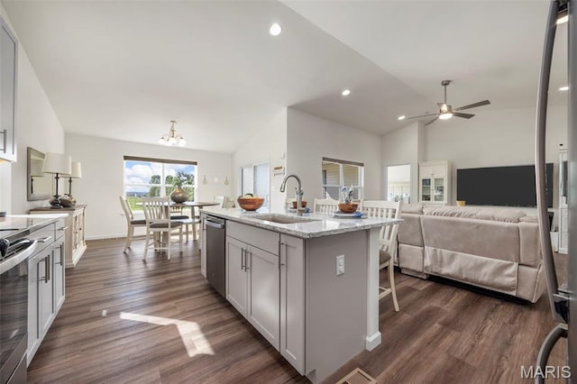 155 Pampano Ln, Saint Charles, MO 63301 - kitchen with vaulted ceiling, appliances with stainless steel finishes, dark wood-type flooring, a ceiling fan, and light stone counters