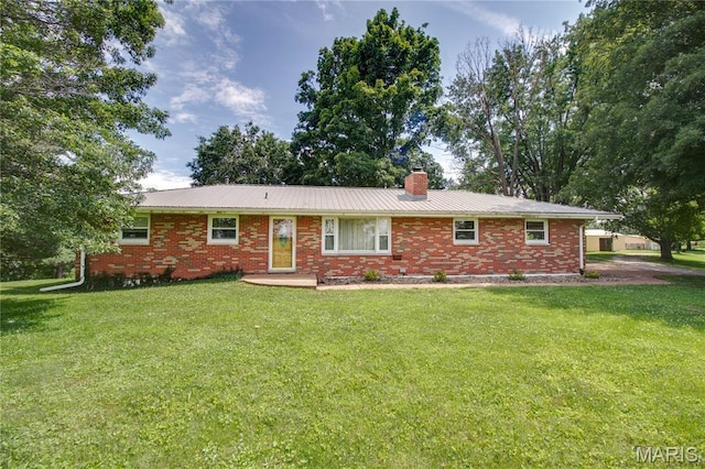 6155 Raymond Rd, Bunker Hill, IL 62014 - view of front of property featuring a chimney, a front yard, brick siding, and a metal roof