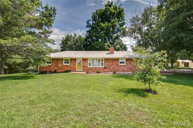 6155 Raymond Rd, Bunker Hill, IL 62014 - view of front of property featuring a chimney, a front yard, brick siding, and a metal roof