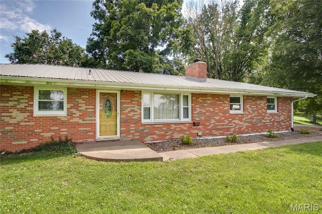 6155 Raymond Rd, Bunker Hill, IL 62014 - ranch-style house featuring a front lawn, a chimney, brick siding, and a metal roof