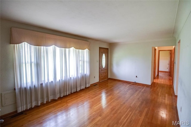 6155 Raymond Rd, Bunker Hill, IL 62014 - unfurnished living room with light wood-style flooring and baseboards