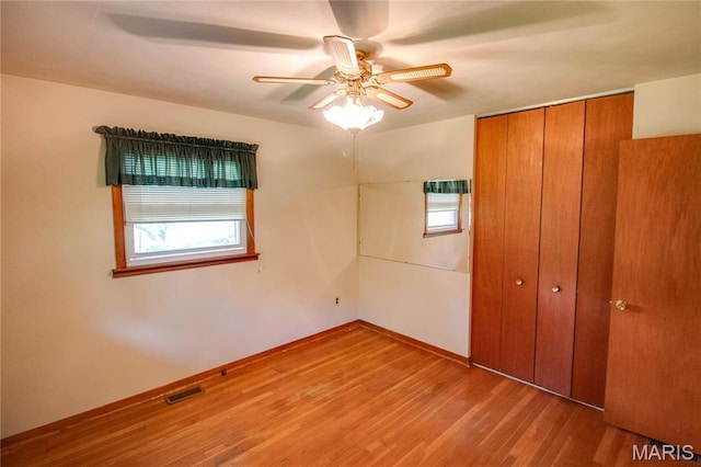 6155 Raymond Rd, Bunker Hill, IL 62014 - unfurnished bedroom featuring a closet, wood finished floors, and ceiling fan