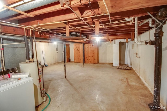 6155 Raymond Rd, Bunker Hill, IL 62014 - unfinished below grade area with water heater and washer and clothes dryer