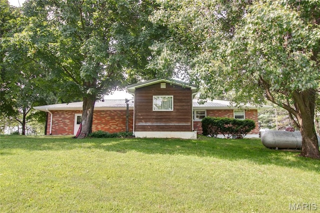 6155 Raymond Rd, Bunker Hill, IL 62014 - view of front of house featuring a front yard, a metal roof, and brick siding