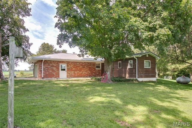 6155 Raymond Rd, Bunker Hill, IL 62014 - back of house featuring a yard and brick siding