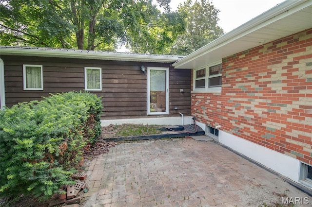 6155 Raymond Rd, Bunker Hill, IL 62014 - view of exterior entry featuring a patio area and brick siding