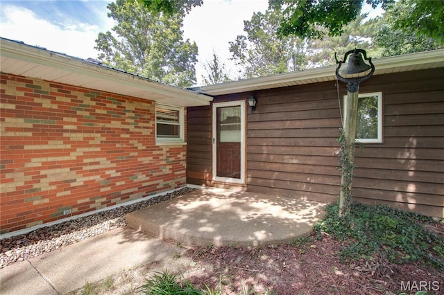 6155 Raymond Rd, Bunker Hill, IL 62014 - view of exterior entry featuring a patio and brick siding