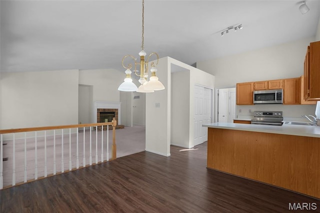 527 Wetherby Terrace Dr, Ballwin, MO 63021 - kitchen with appliances with stainless steel finishes, open floor plan, dark wood-style flooring, track lighting, and light countertops