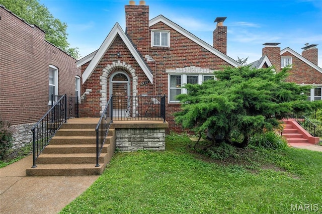 5414 Lansdowne Ave, Saint Louis, MO 63109 - tudor-style house featuring brick siding, a chimney, and a front yard