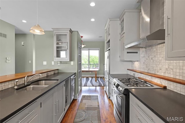 5310 Chouteaus Bluff Dr Unit 5310, Saint Louis, MO 63111 - kitchen with stainless steel appliances, wall chimney range hood, dark countertops, dark wood-style floors, and recessed lighting