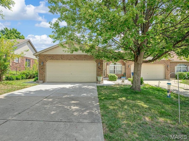 344 Westline Ct, Shiloh, IL 62221 - view of front of home with concrete driveway, an attached garage, brick siding, and a front lawn