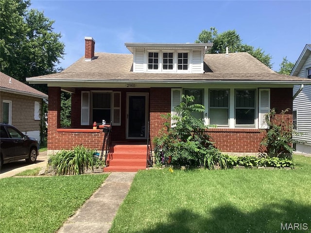 2965 Kincaid Ave, St John, MO 63114 - bungalow-style house featuring brick siding, a chimney, covered porch, and a front lawn