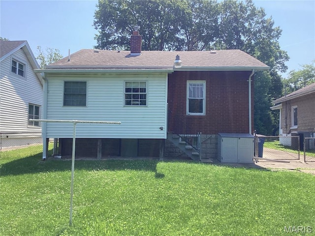 2965 Kincaid Ave, St John, MO 63114 - back of property featuring a chimney, stairs, roof with shingles, and brick siding
