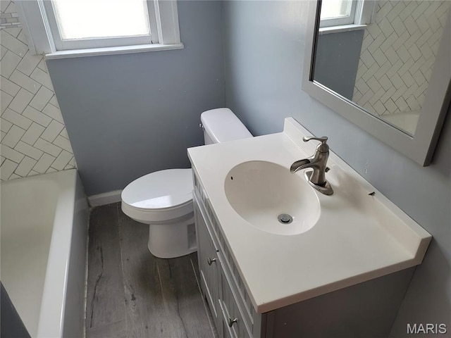2965 Kincaid Ave, St John, MO 63114 - full bath with vanity, a bathtub, and wood finished floors