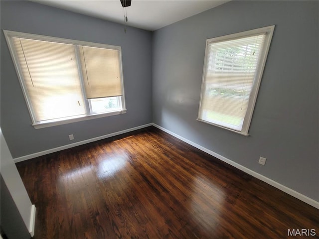2965 Kincaid Ave, St John, MO 63114 - empty room with healthy amount of natural light and dark wood-style floors