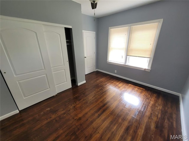 2965 Kincaid Ave, St John, MO 63114 - unfurnished bedroom featuring dark wood-type flooring and a closet