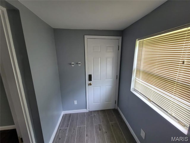 2965 Kincaid Ave, St John, MO 63114 - doorway to outside featuring dark wood-type flooring and baseboards