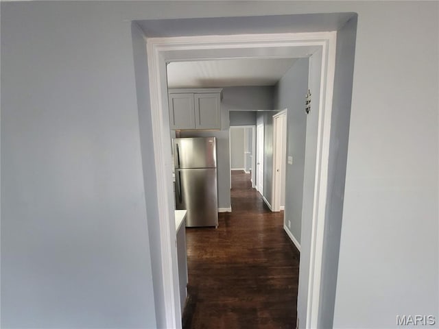 2965 Kincaid Ave, St John, MO 63114 - corridor with baseboards and dark wood-type flooring