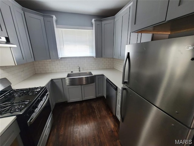 2965 Kincaid Ave, St John, MO 63114 - kitchen featuring appliances with stainless steel finishes, dark wood-style floors, tasteful backsplash, and range hood