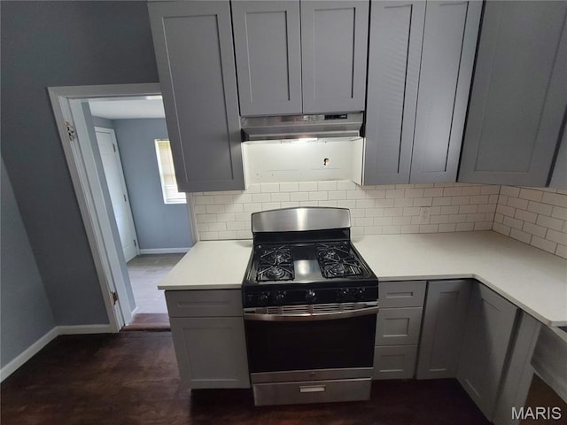 2965 Kincaid Ave, St John, MO 63114 - kitchen with gas range, under cabinet range hood, decorative backsplash, and gray cabinetry